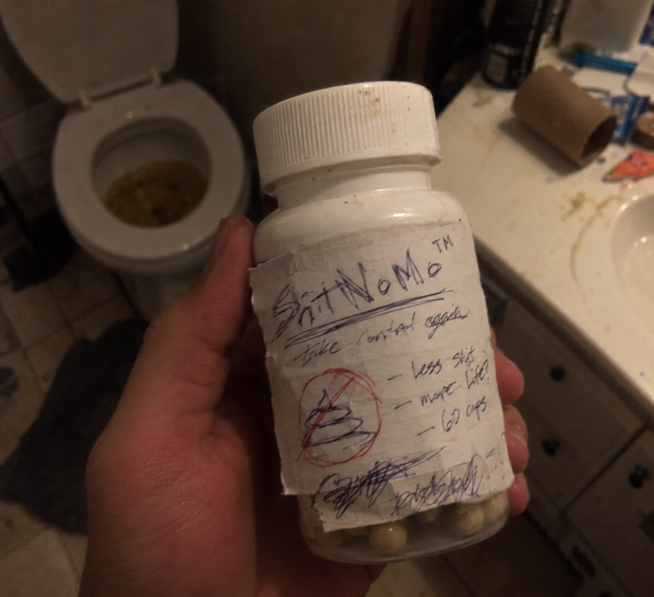 ShitNoMo bottle with a handwritten label