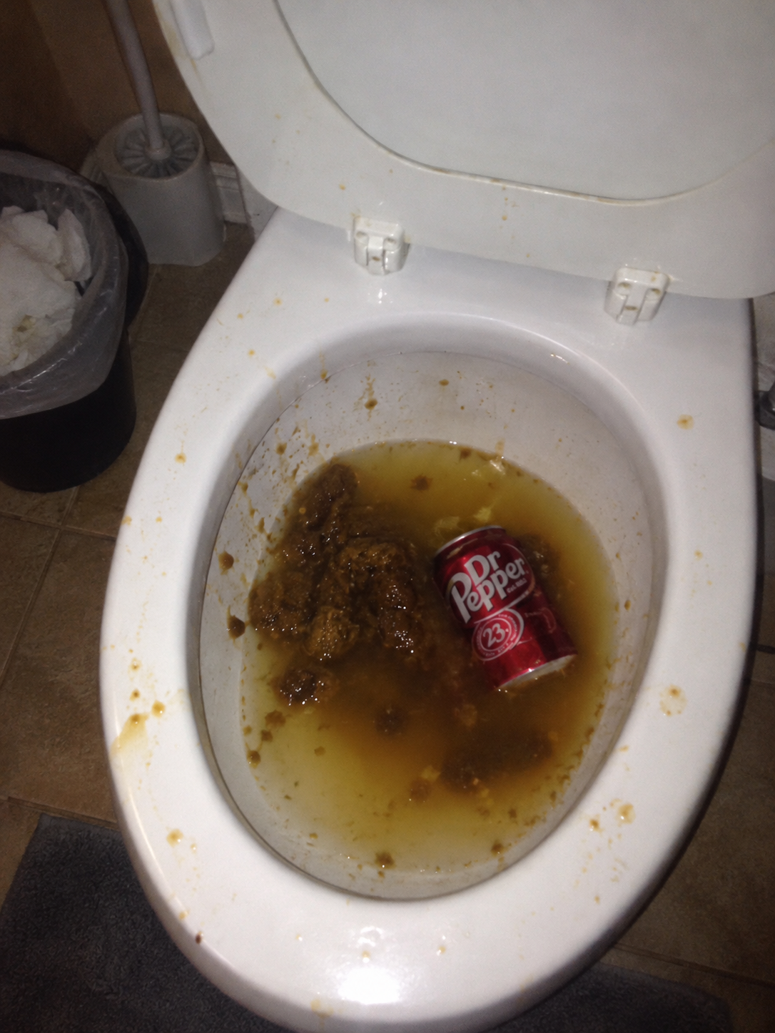 Dr Pepper can in a dirty toilet